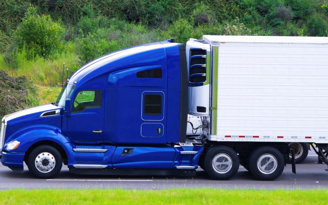 Semi-truck rolls after colliding with construction vehicle